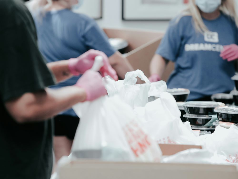 Workers packing and checking food orders for distribution